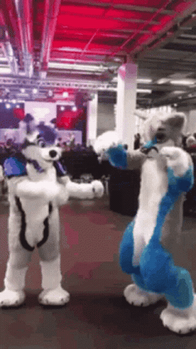 Two Furry Costumes Standing Next To Each Other GIF