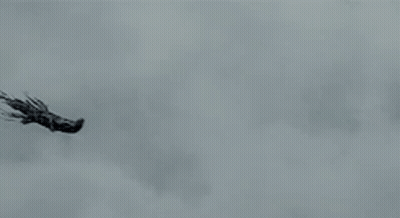 Two Ghosts Are Flying Through The Air In A Cloudy Sky GIF