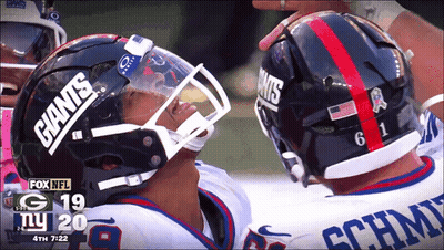 Two Giants Football Players Looking At Each Other GIF