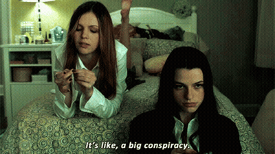 Two Girls Are Laying On A Bed And One Of Them Says It 'S Like A Big Conspiracy GIF