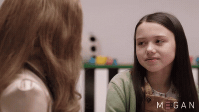 Two Girls Are Looking At Each Other With The Name Megan On The Bottom Right GIF