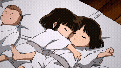 Two Girls Are Sleeping On A Bed Next To A Baby Wrapped In A Blanket GIF