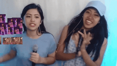 Two Girls Are Standing Next To Each Other And One Has A Microphone GIF