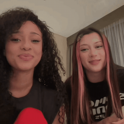 Two Girls Are Standing Next To Each Other With One Wearing A Shirt That Says ' S2 ' On It GIF