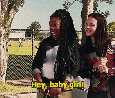 Two Girls Are Standing Next To Each Other With The Words Hey Baby Girl Written On The Bottom GIF