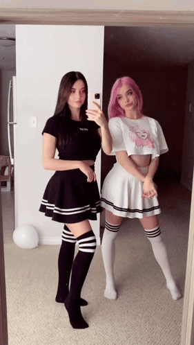 Two Girls Are Taking A Selfie In Front Of A Mirror And One Of Them Has Pink Hair GIF