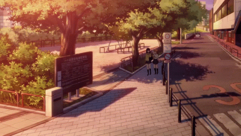 Two Girls Are Walking Down A Sidewalk Next To A Sign That Says No Smoking GIF