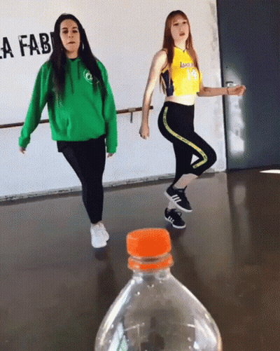 Two Girls Dancing In Front Of Lafab Sign GIF