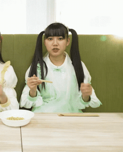 Two Girls Eating With Chopsticks GIF