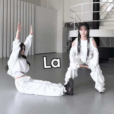 Two Girls Exercising In Room With La On Floor GIF