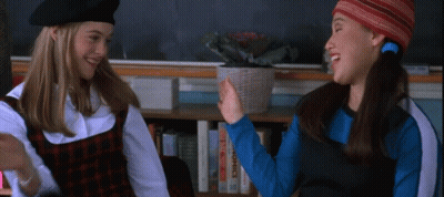 Two Girls High Five By Bookshelf GIF