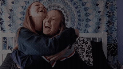 Two Girls Hugging And Laughing Saying Hi GIF