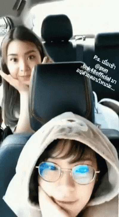 Two Girls In Back Seat Of Car One With Glasses And Hood GIF