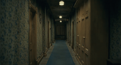 Two Girls In Blue Dresses Holding Hands In Dark Hallway GIF