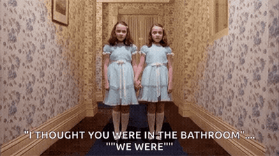 Two Girls In Blue Dresses In Hallway GIF