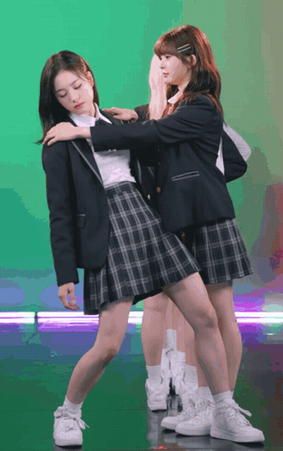 Two Girls In School Uniforms Are Posing For A Photo GIF