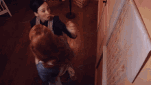 Two Girls Installing Wallpapers GIF
