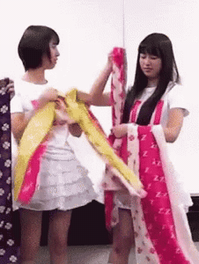 Two Girls One Holding Clothes In White Shirt Letter Z GIF