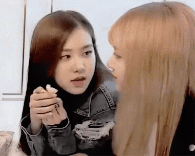 Two Girls One Holding Key Looking At Each Other GIF