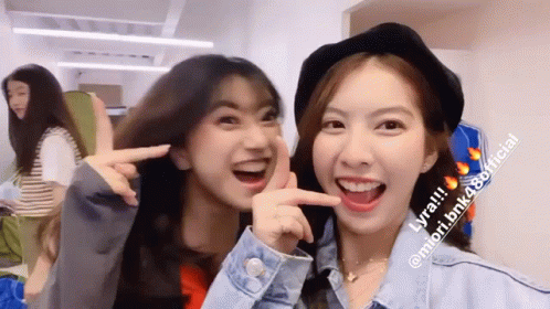 Two Girls Posing, One Hat, One Denim Jacket GIF