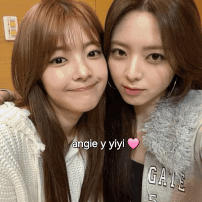 Two Girls Posing, One In Angie Y Yiyi Shirt GIF