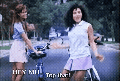 Two Girls Riding Bikes Saying Hey Mu Top That GIF