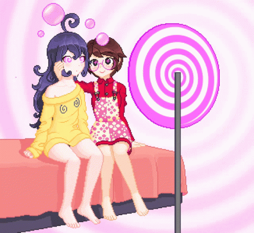 Two Girls Sit On A Bed Next To A Lollipop GIF