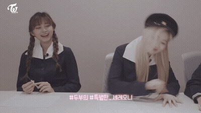 Two Girls Sitting At Table With Twice GIF