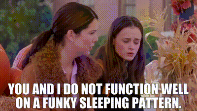 Two Girls Sitting In Pumpkin Patch One Talking To Other GIF