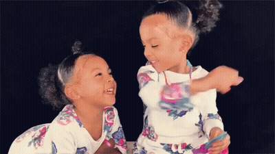 Two Girls Sitting Next To Each Other GIF