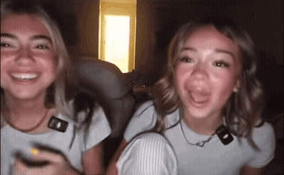 Two Girls Sitting Smiling GIF