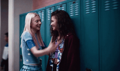 Two Girls Standing In Front Of Blue Lockers GIF