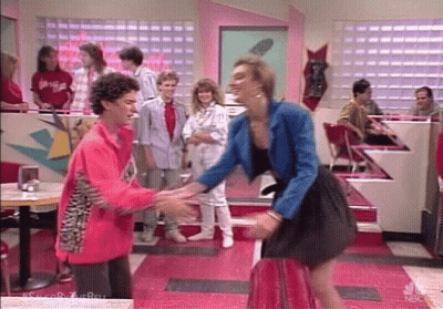 Two Girls Standing In Front Of Red Lockers GIF