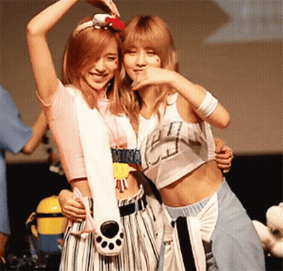 Two Girls Standing Next To Each Other One With Mina Necklace GIF