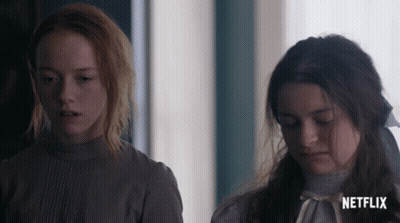 Two Girls Standing Next To Each Other With A Netflix Logo On The Bottom Right GIF