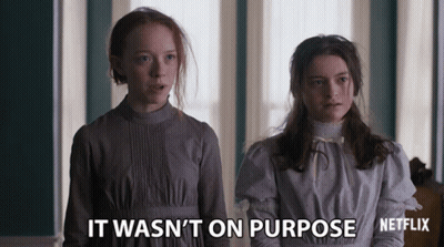 Two Girls Standing Next To Each Other With The Words " It Wasn 'T On Purpose " Written On The Bottom GIF