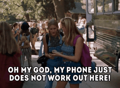 Two Girls Standing Next To Each Other With The Words Oh My God My Phone Just Does Not Work Out Here On The Bottom GIF