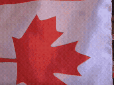 Two Girls Wearing Red Cowboy Hats And Holding Canadian Flags GIF