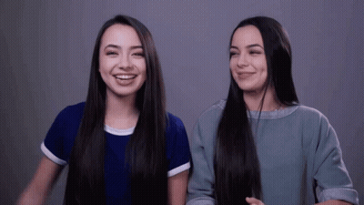 Two Girls With Long Hair Smiling GIF