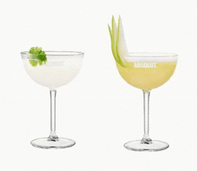Two Glasses Of Absolut Vodka Are Sitting Next To Each Other On A White Background GIF