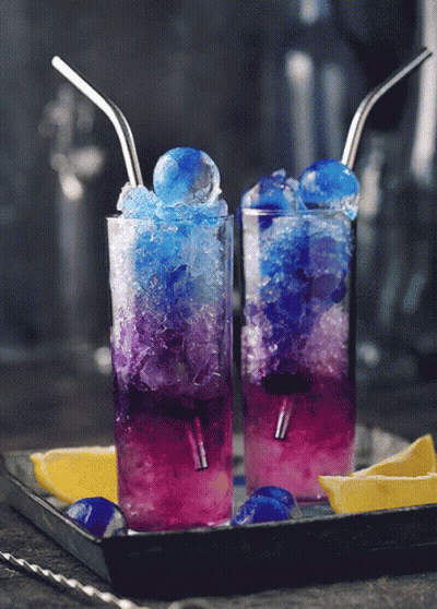 Two Glasses Of Blue And Purple Drinks With Straws GIF