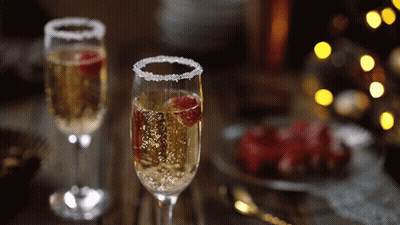 Two Glasses Of Champagne With Raspberries GIF