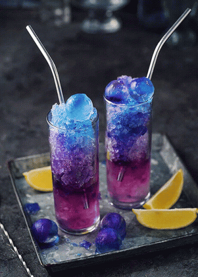 Two Glasses Of Purple And Blue Drinks With Straws GIF