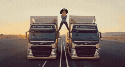 Two Globetrotter Trucks Are On The Road With A Man Standing On Top Of One GIF