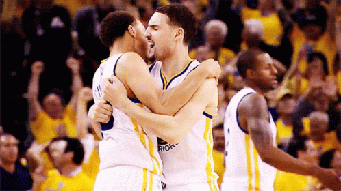Two Golden State Warriors Basketball Players Are Hugging Each Other GIF