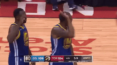 Two Golden State Warriors Players On The Court During A Game Against The Raptors GIF