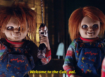 Two Good Guys Dolls Are Standing Next To Each Other Holding Guns And Saying Welcome To The Cult Pal GIF