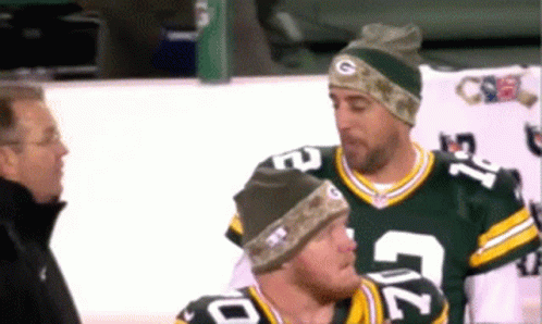 Two Green Bay Packers Players Are Talking To A Man GIF