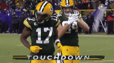 Two Green Bay Packers Players Celebrate A Touchdown On The Field GIF