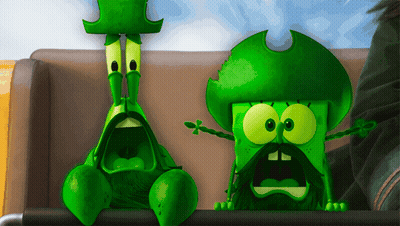 Two Green Cartoon Characters Sitting On Couch GIF